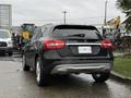 A black 2016 Mercedes-Benz GLA-250 parked with its rear visible showcasing its sleek design and four-wheel drive badge