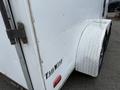 A white 2016 Continental cargo trailer with a silver diamond plate wheel fender and a small red light on the side