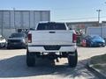 A white 2018 RAM 3500 truck viewed from the rear with high clearance and large tires