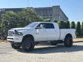 A white 2018 RAM 3500 truck with a high clearance and black wheels parked on a driveway