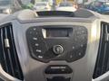 Dashboard of a 2016 Ford Transit 150 featuring a radio display and control buttons for sound and menu settings