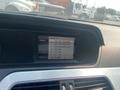 2013 Mercedes-Benz C-Class dashboard display showing radio stations and audio options
