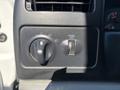 Image shows the control panel of a 2004 Ford F-750 featuring knobs for lights and panel dimming with clear labels