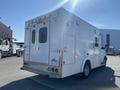 A white 2011 Chevrolet Express vehicle designed for emergency response with a rear entrance and tail lights