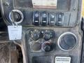 Controls and dashboard of a 2013 JCB 510-56 Loadall featuring buttons knobs and an emergency shutdown label