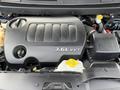 Close-up of a 3.6L VVT engine cover from a 2013 Dodge Journey with visible labels and components