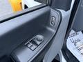 Interior view of a 2023 Ford F-250 door control panel featuring window and mirror adjustment controls