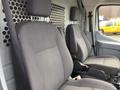 Two grey fabric seats in a 2017 Ford Transit van's cabin with a partition behind them