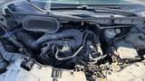 Engine compartment of a 2021 Ford Transit showing various components including the air intake system and electrical parts