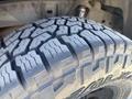 Close-up of a tire from a 2010 Toyota Tacoma showing the tread patterns and rubber surface details
