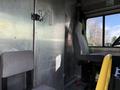 Interior of a 2017 Freightliner MT45 with a driver's seat and a passenger seat visible near a metal wall