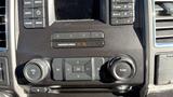 2016 Ford F-150 dashboard controls including buttons for volume navigation and climate settings