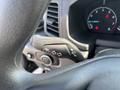 Close-up of a 2025 Ford Transit T-350 steering column with control stalk for turn signals and headlights visible