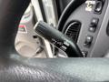 A close-up view of the turn signal and headlight controls on a 2013 Freightliner 114SD steering wheel