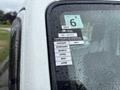 A white 2008 Suzuki Carry with a certificate of approval sticker on the window displaying the months from January to June and additional details