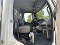 Interior of a 2010 Freightliner M2 106 showing two gray seats dashboard with controls and steering wheel
