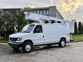 A white 2007 Ford Econoline van with an elevated bucket lift attached to its roof