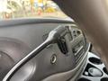 Close-up of a 2008 Ford Econoline dashboard featuring a radio control knob and various dials and buttons