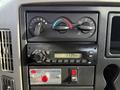 Dashboard controls of a 2012 International DuraStar 4300 including climate controls and a radio display showing the time