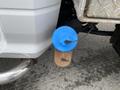 A blue sensor attached to a cylindrical metal object with a brown base connected to a 2011 Dodge Ram 5500