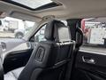 Interior view of a 2015 Dodge Durango with a headrest mounted screen and leather seats showing features like control buttons on the seat back