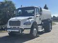 A white 2022 Freightliner M2 106 truck with a large tank on the back and chrome accents on the front