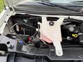 2015 GMC Savana engine compartment showing coolant reservoir battery and various components
