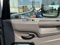 Close-up of the door panel of a 2020 Peterbilt 330 showing the handle and window controls