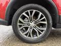 A close-up view of a 2016 Mitsubishi Outlander wheel featuring a multi-spoke alloy rim and a black tire with prominent tread pattern