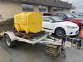 2014 Express 8 Foot Trailer with a large yellow water tank mounted on it and features a metal frame and axle assembly