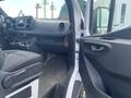 Interior view of a 2024 Mercedes-Benz Sprinter showcasing the driver's seat dashboard and controls