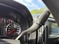 A close-up view of the steering column controls in a 2016 Chevrolet Silverado 2500HD featuring a gearshift lever and instrument cluster with speedometer and warning lights