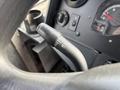 Close-up of the turn signal lever on a 2018 Ford Econoline showing markings for left and right turn signals