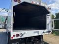 2019 Freightliner M2 106 truck with an open cargo area showing a clean black interior and red tail lights