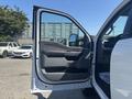 The image shows the open driver's side door of a 2023 Ford F-350 SD featuring a black interior with a handle and storage area in the door panel