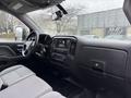Interior view of a 2015 GMC Sierra 1500 showing the dashboard steering wheel and seats highlighted by a grey color scheme and control buttons