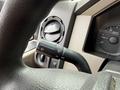 Close-up of the steering wheel and controls of a 2008 Ford F-550 showing the turn signal and wiper control stalk