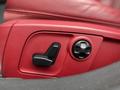 Close-up of the seat adjustment controls in a 2016 Maserati Ghibli featuring a red leather seat and buttons for adjusting the seat position and lumbar support