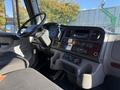 Interior view of a 2012 Freightliner M2 106 showing the dashboard with controls and a steering wheel