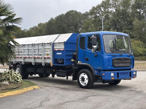 A blue 2017 Autocar Xpert truck with a large silver cargo bed designed for hauling materials and equipped with a side door for easy access to the cargo area