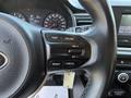 Close-up of the steering wheel controls of a 2018 Kia Rio5 featuring buttons for trip, cruise, reset, and cancel