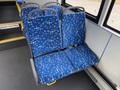 Blue patterned seats in a Grande West Vicinity bus with a modern design and spacious layout