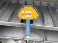 A blue and yellow control panel with buttons labeled CW EXTEND RAISE CCW RETRACT LOWER attached to a cable