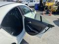 A 2014 Mercedes-Benz CLA-Class with an open driver's side door showcasing the interior and door design