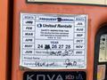 A safety inspection tag for a 2009 JLG E300AJP showing the months of use, the next inspection date, and a printed name and signature