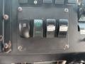Control panel of a 2011 Workhorse W62 featuring switches for overdrive, heated mirrors, front beacon, and rear beacon