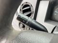 Close-up of a turn signal lever from a 2014 Ford F-550 featuring controls for headlights and windshield wipers
