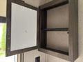 An open cabinet with a wood frame and a white interior in a 2021 Jayco Jay Flight camper