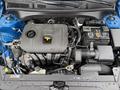 A 2021 Kia Forte engine bay showing a sleek engine design with various components including the air intake and battery mounted on either side