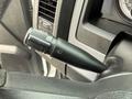Close-up of the turn signal lever in a 2013 RAM 3500 featuring a textured grip and control for turn signals and windshield wipers